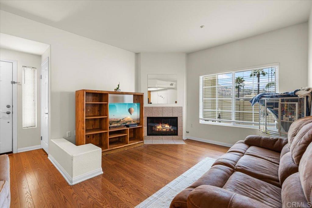 2715 Lake Pointe Drive, Unit 116 Spring Valley, CA 91977 - Photo 5 of 23 a living room with furniture windows and a fireplace