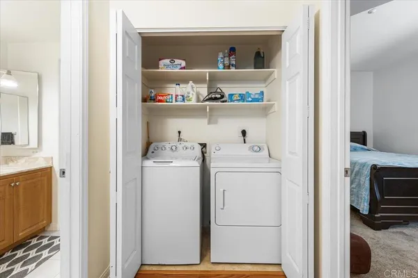 a view of washer and dryer with kitchen in the background
