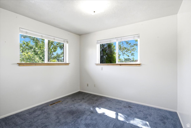 2252 West 800 North Clinton, UT 84015 - Photo 19 of 38 Neutral white walls with two windows featuring wood window sills