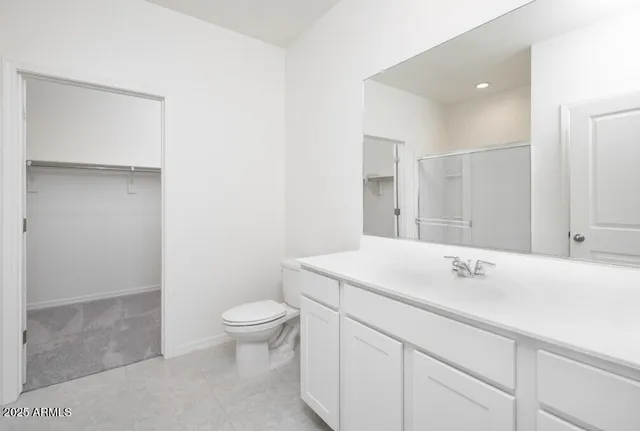 a bedroom with a bed and a couch next to a window