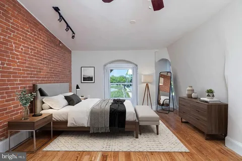 a bed room with a bed and a potted plant