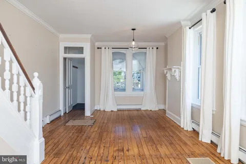 a view of interior space with wooden floor and window