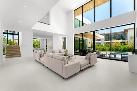 a living room with furniture and large windows