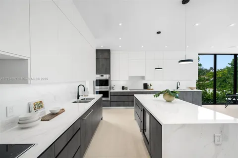 a kitchen that has a sink and a stove in it