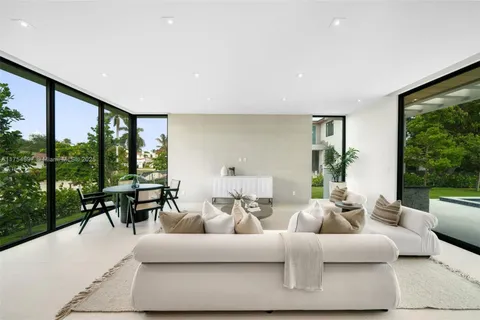 a view of a porch with chairs and backyard
