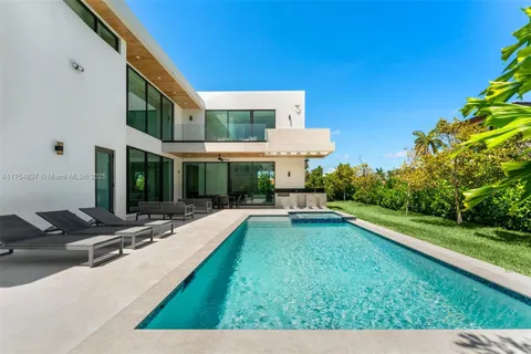 a swimming pool with outdoor seating