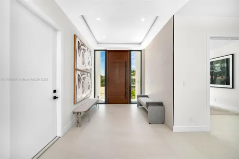 a living room with furniture and large windows