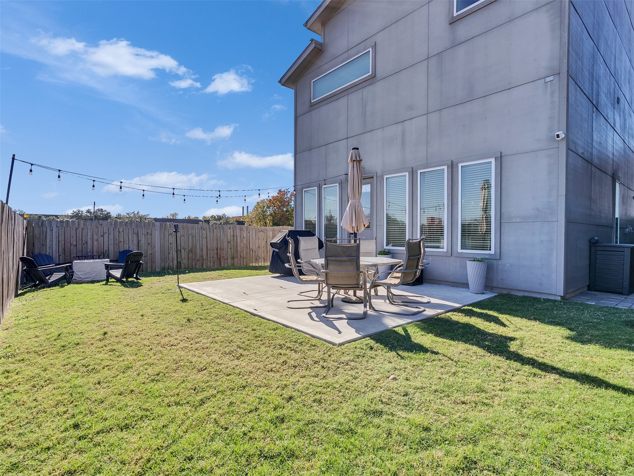 5702 Rucio Lane Houston, TX 77092 - Photo 27 of 30 a view of a backyard with table and chairs potted plants and wooden fence