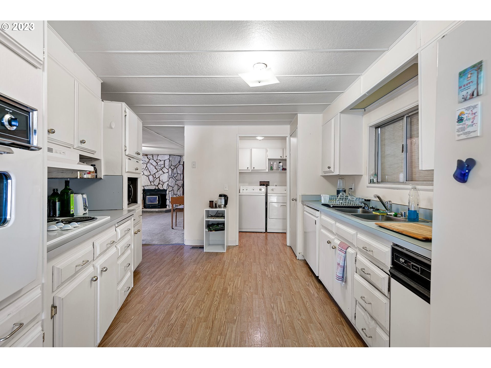 3530 East Game Farm Road Springfield, OR 97477 - Photo 23 of 38 a large kitchen with stainless steel appliances lots of counter space and wooden floor