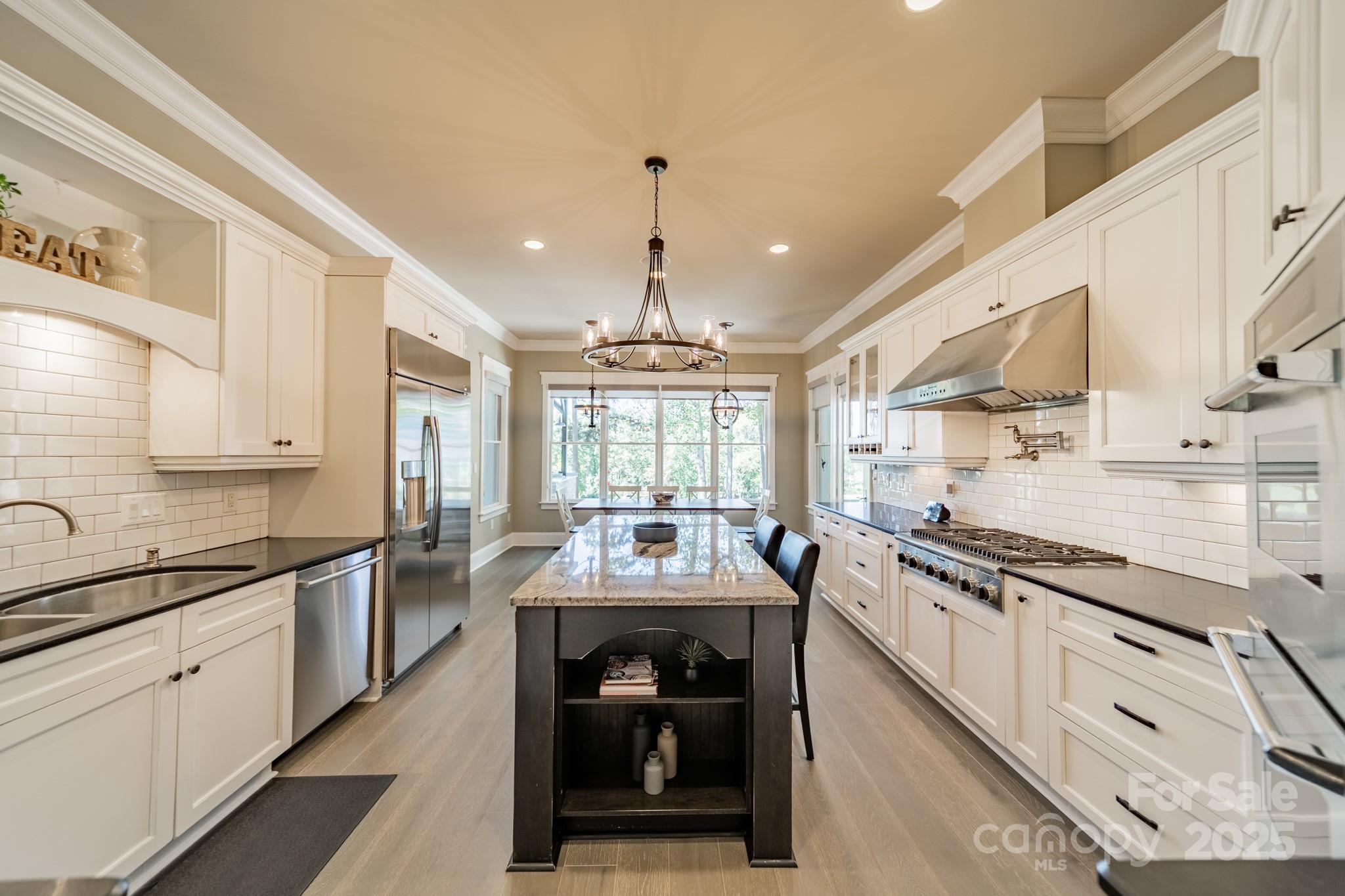 1946 Brawley School Road Mooresville, NC 28117 - Photo 20 of 48 a kitchen with stainless steel appliances a sink stove and cabinets