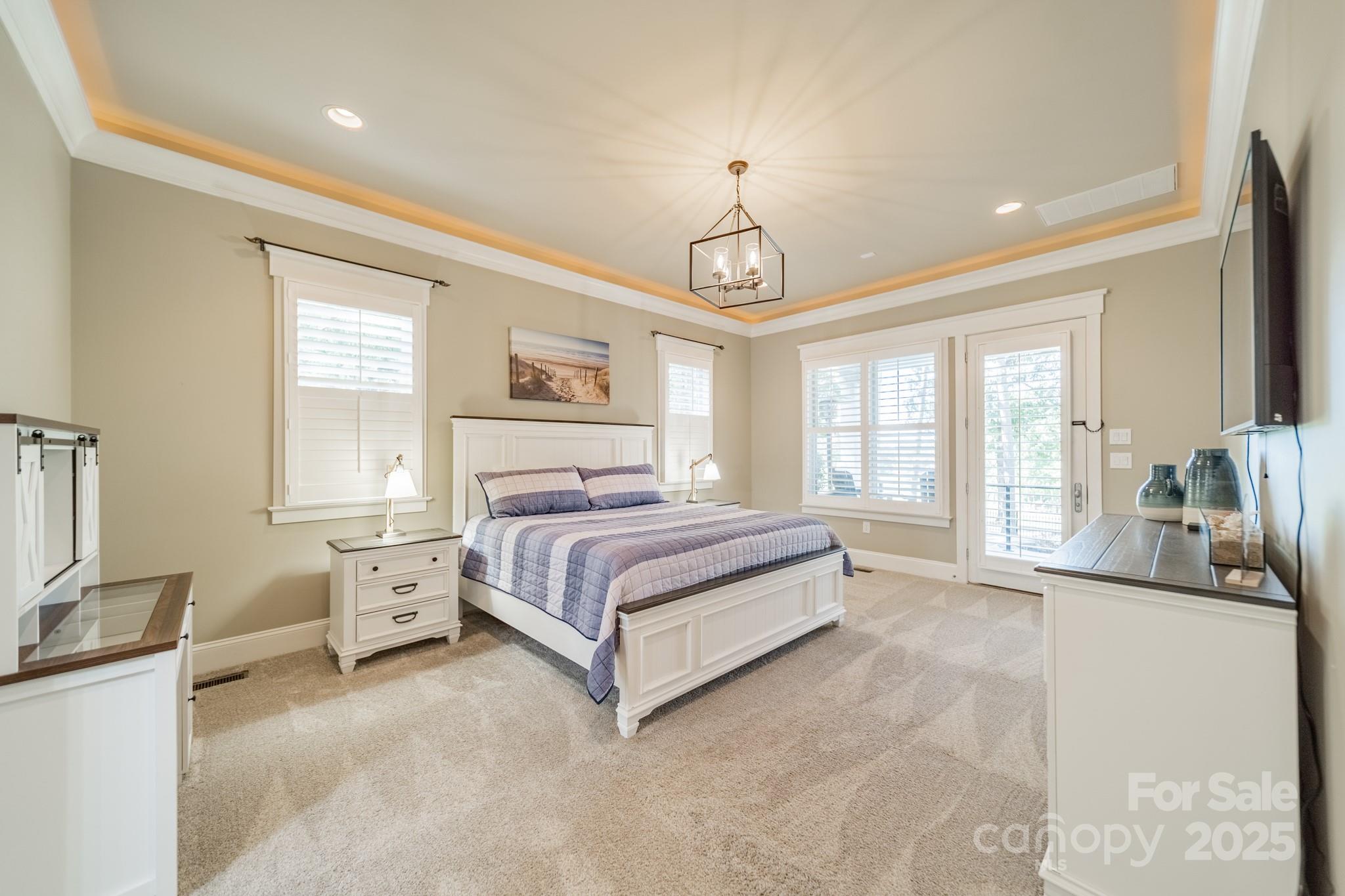 1946 Brawley School Road Mooresville, NC 28117 - Photo 25 of 48 a spacious bedroom with a bed and glass windows