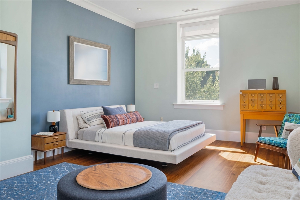 232 Summit Avenue, Unit A5 Brookline, MA 02446 - Photo 13 of 21 a bedroom with a bed a couch and a window