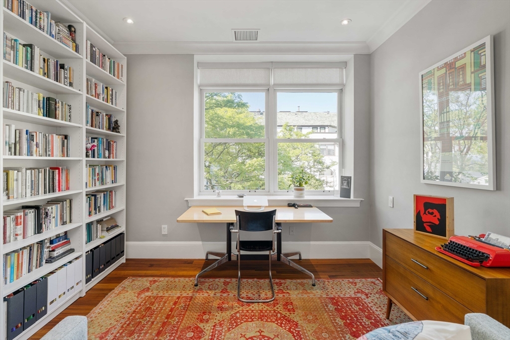 232 Summit Avenue, Unit A5 Brookline, MA 02446 - Photo 19 of 21 a living room with furniture a bookshelf and a window