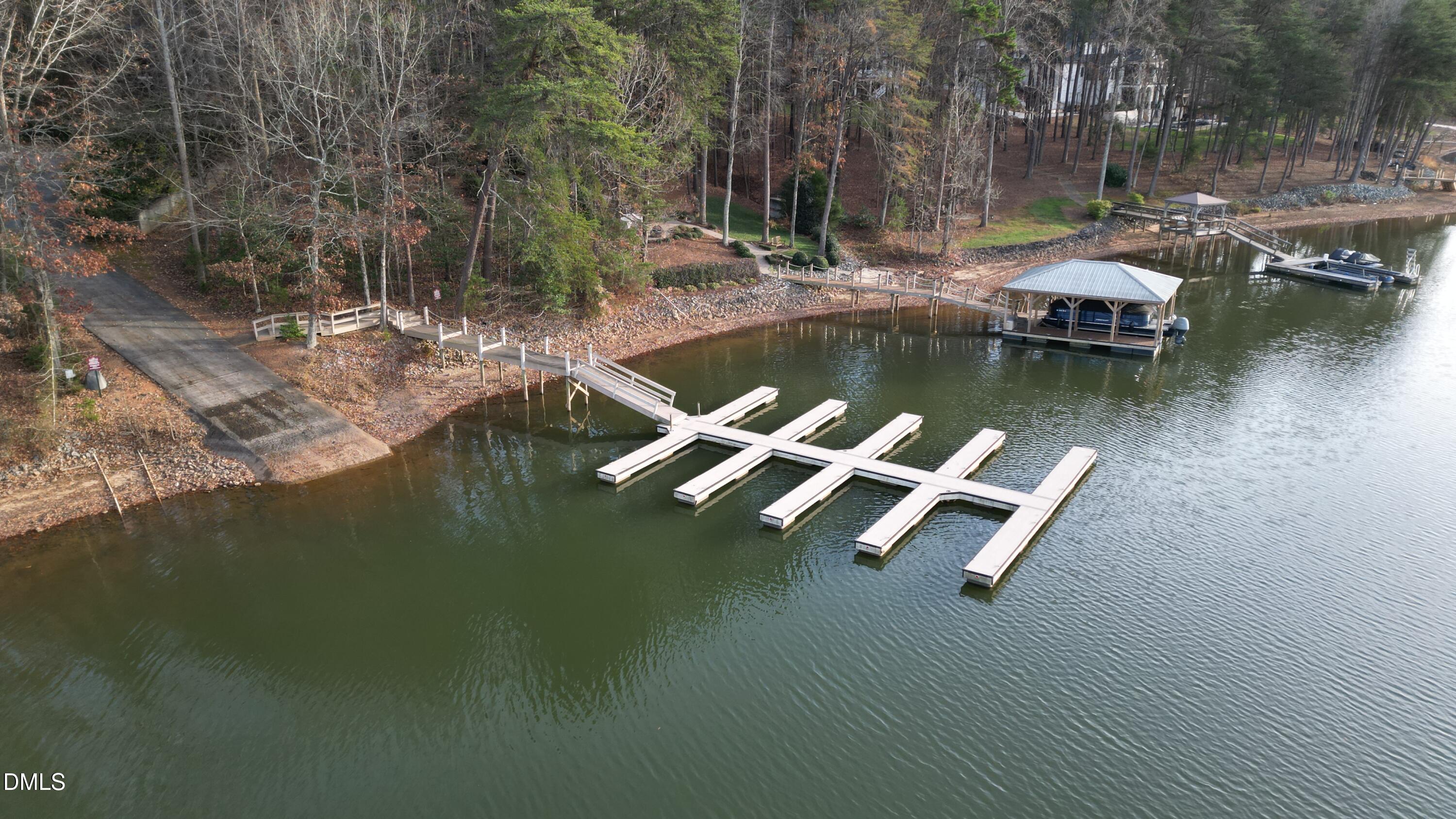 6682 Goose Point Drive Denver, NC 28037 - Photo 3 of 5 a view of a lake with a bench and trees