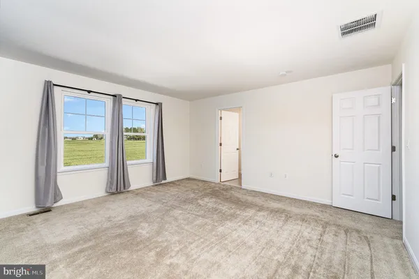 a bathroom with double sink and a mirror