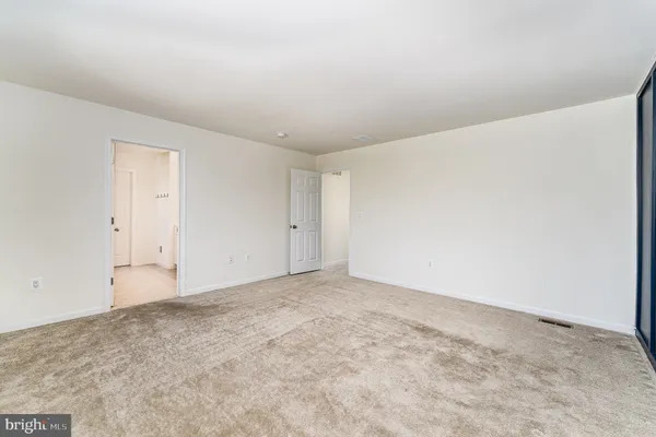 a bathroom with a shower and a glass door