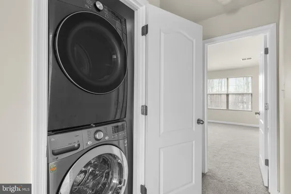 a view of a hallway with washer and dryer