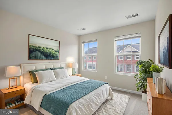 a bedroom with a bed and a potted plant