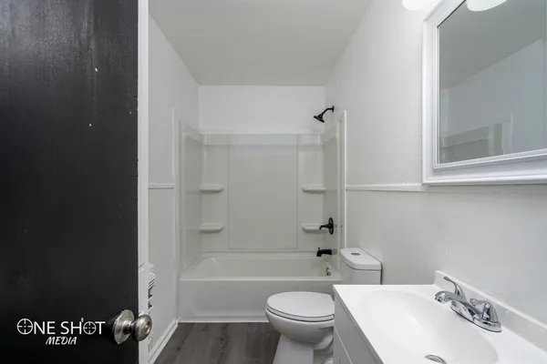 a bathroom with a sink toilet tub and shower