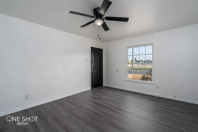 wooden floor in an empty room with a window