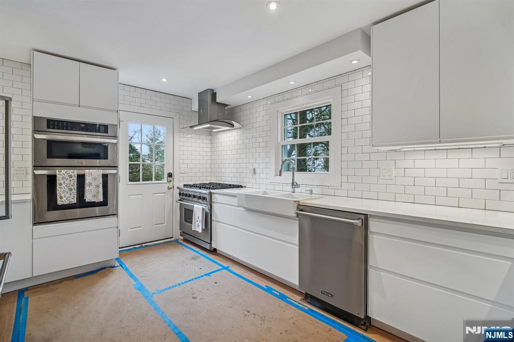 395 Highview Road Englewood, NJ 07631 - Photo 4 of 13 a kitchen with a sink stove and microwave