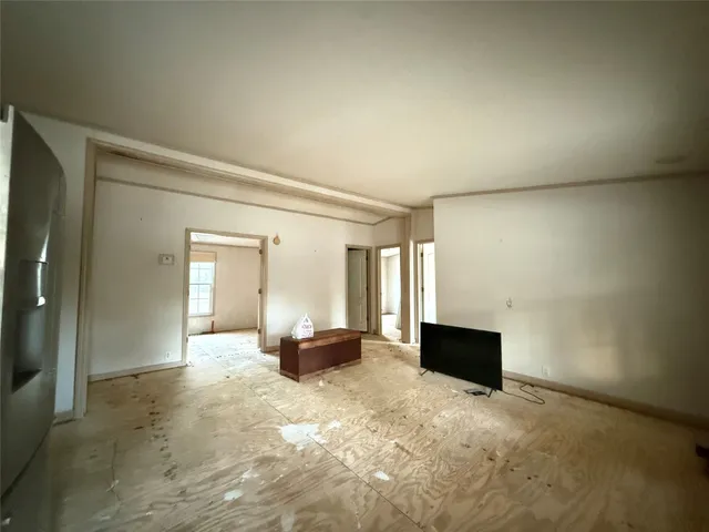 a living room with a couch and a dresser next to a window