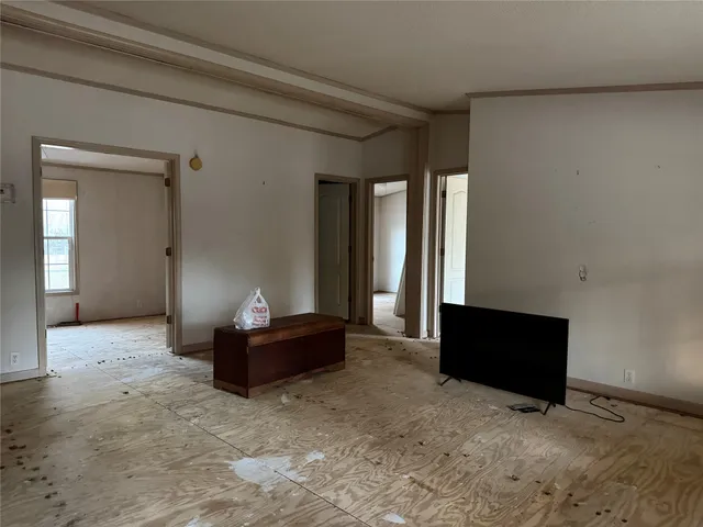 wooden floor in an empty room and a bathroom
