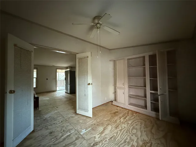 a view of an empty room with a closet