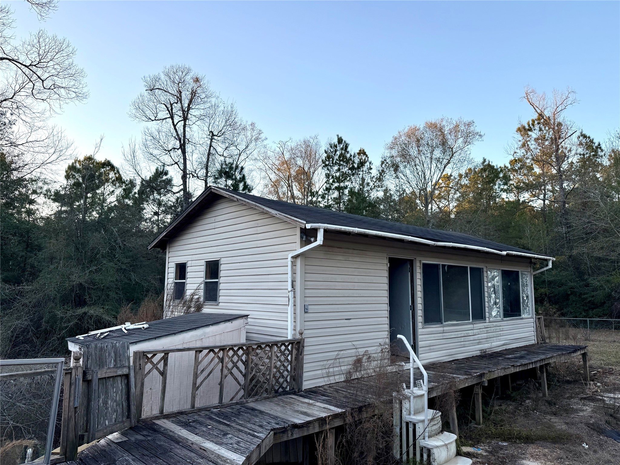 669 County Road 1245 Warren, TX 77664 - Photo 24 of 28 a roof deck with wooden floor and fence