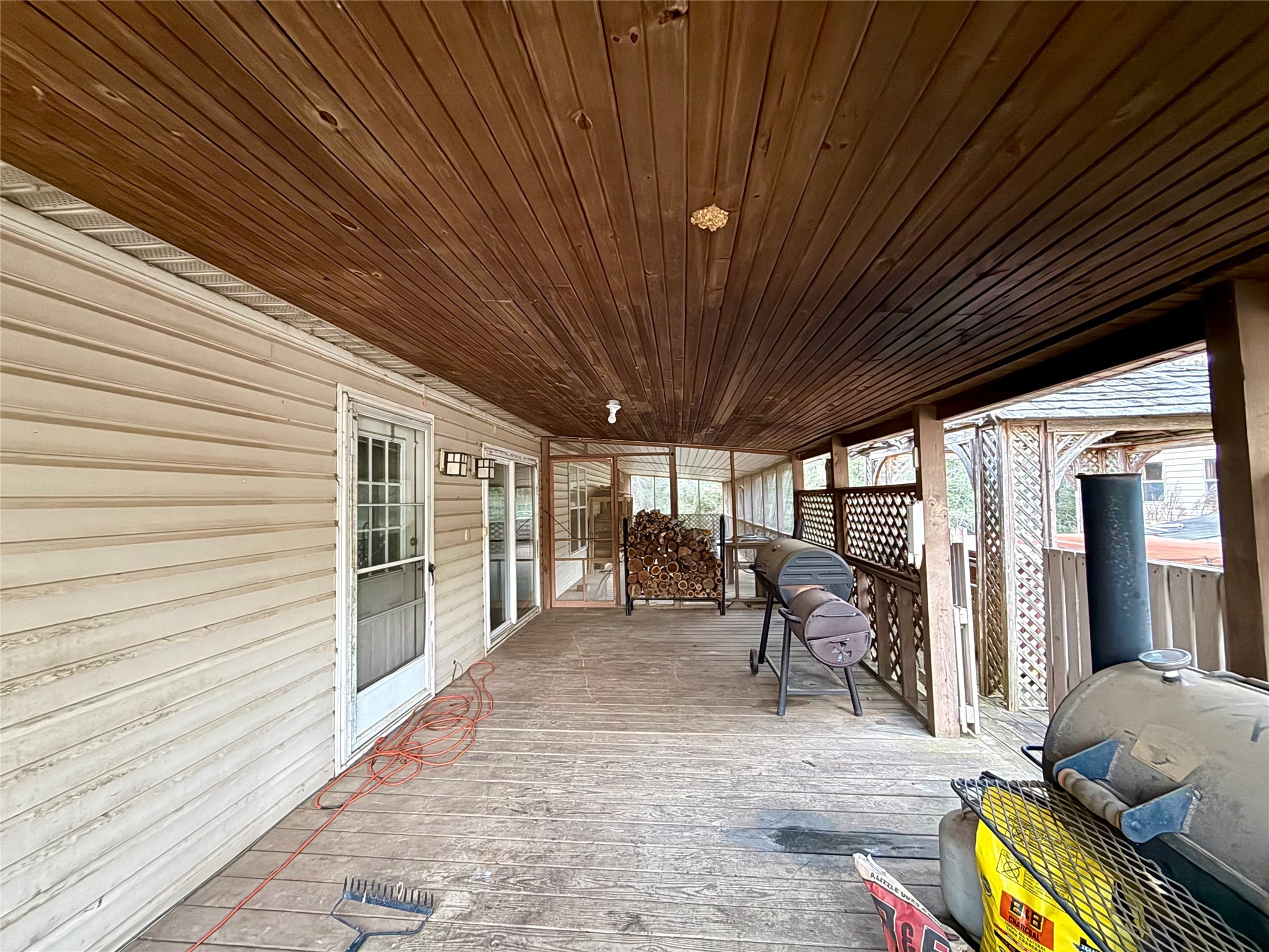 669 County Road 1245 Warren, TX 77664 - Photo 27 of 28 a view of a patio with a table chairs and wooden floor