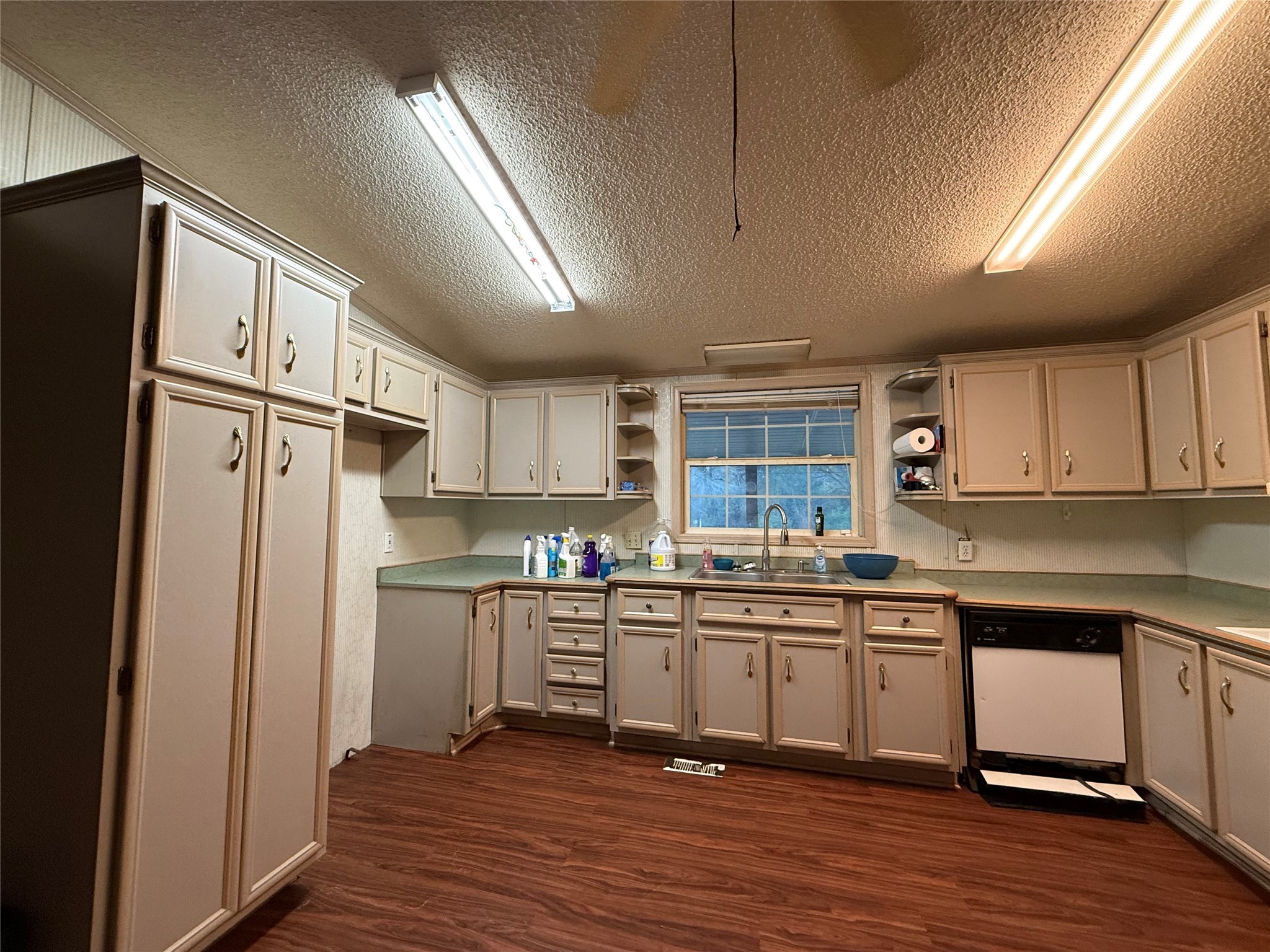 669 County Road 1245 Warren, TX 77664 - Photo 7 of 28 a kitchen with stainless steel appliances granite countertop a refrigerator a sink dishwasher a stove and white cabinets with wooden floor