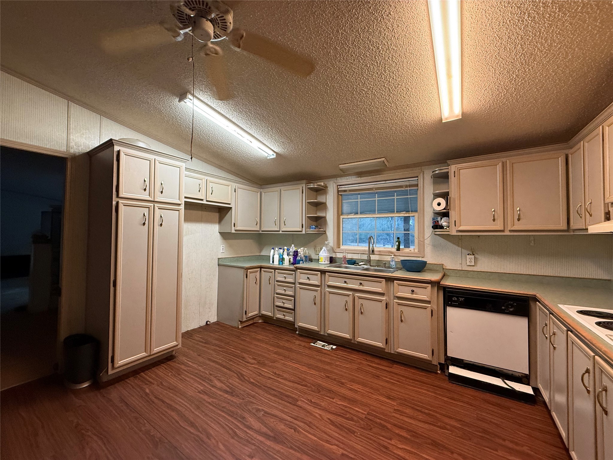 669 County Road 1245 Warren, TX 77664 - Photo 9 of 28 a kitchen with stainless steel appliances granite countertop a refrigerator a sink dishwasher a stove and white countertops with wooden floor