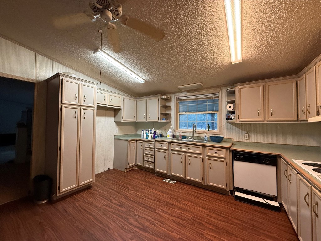 669 County Road 1245 Warren, TX 77664 - Photo 9 of 28 a kitchen with stainless steel appliances granite countertop a refrigerator a sink dishwasher a stove and white countertops with wooden floor