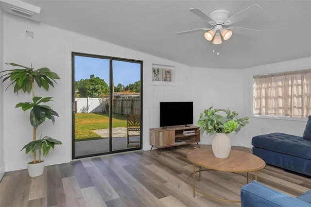 a view of living room filled with furniture and a potted plant