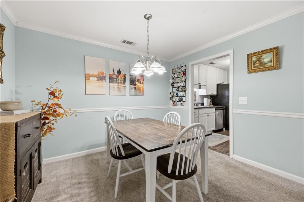 1007 Olde Mill Lane Norcross, GA 30093 - Photo 13 of 32 a view of a dining room with furniture window and wooden floor