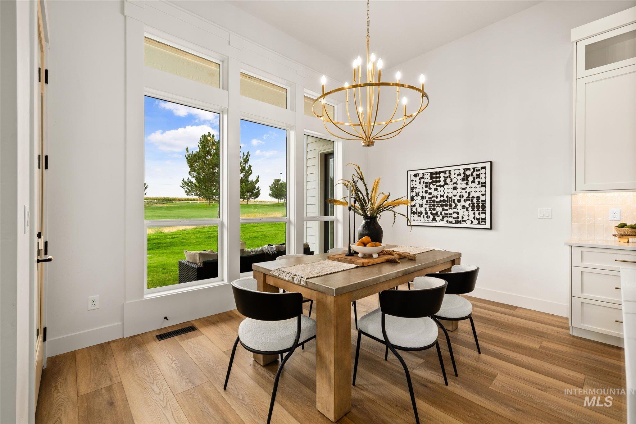 22909 Cirrus Vw Court Caldwell, ID 83607 - Photo 24 of 50 Dining area featuring light wood-style flooring and a chandelier