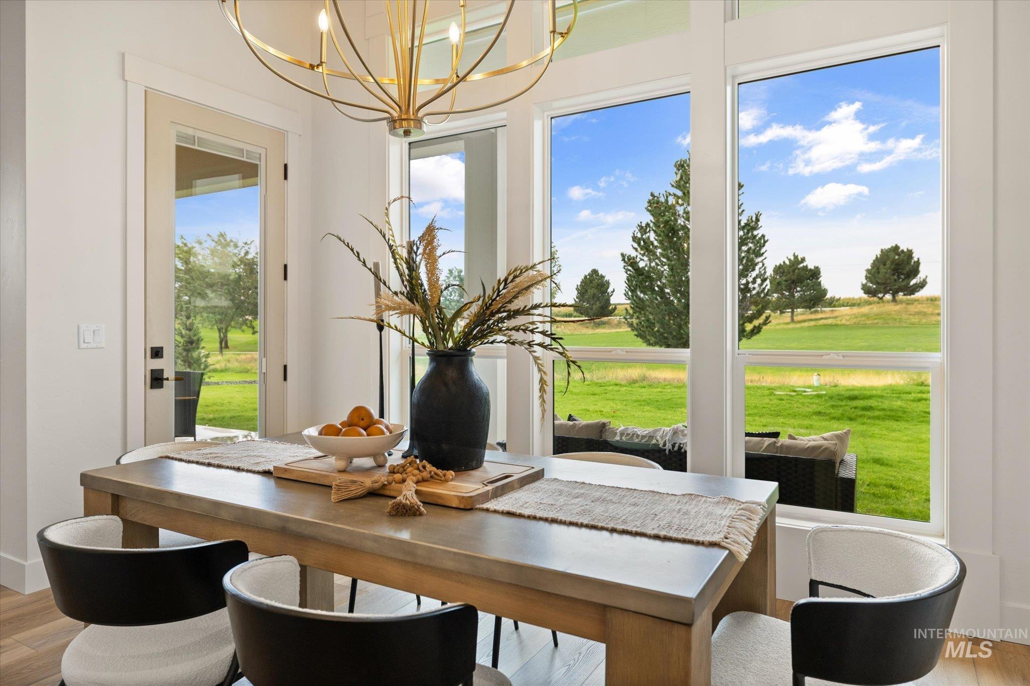 22909 Cirrus Vw Court Caldwell, ID 83607 - Photo 25 of 50 Dining area featuring light wood-style flooring and a chandelier