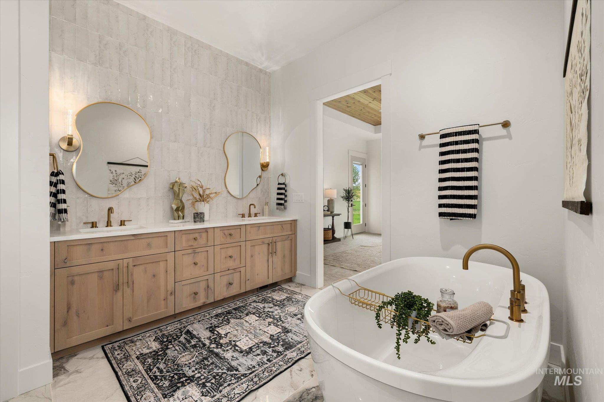 22909 Cirrus Vw Court Caldwell, ID 83607 - Photo 29 of 50 Full bath with a freestanding bath, double vanity, and light marble finish floors