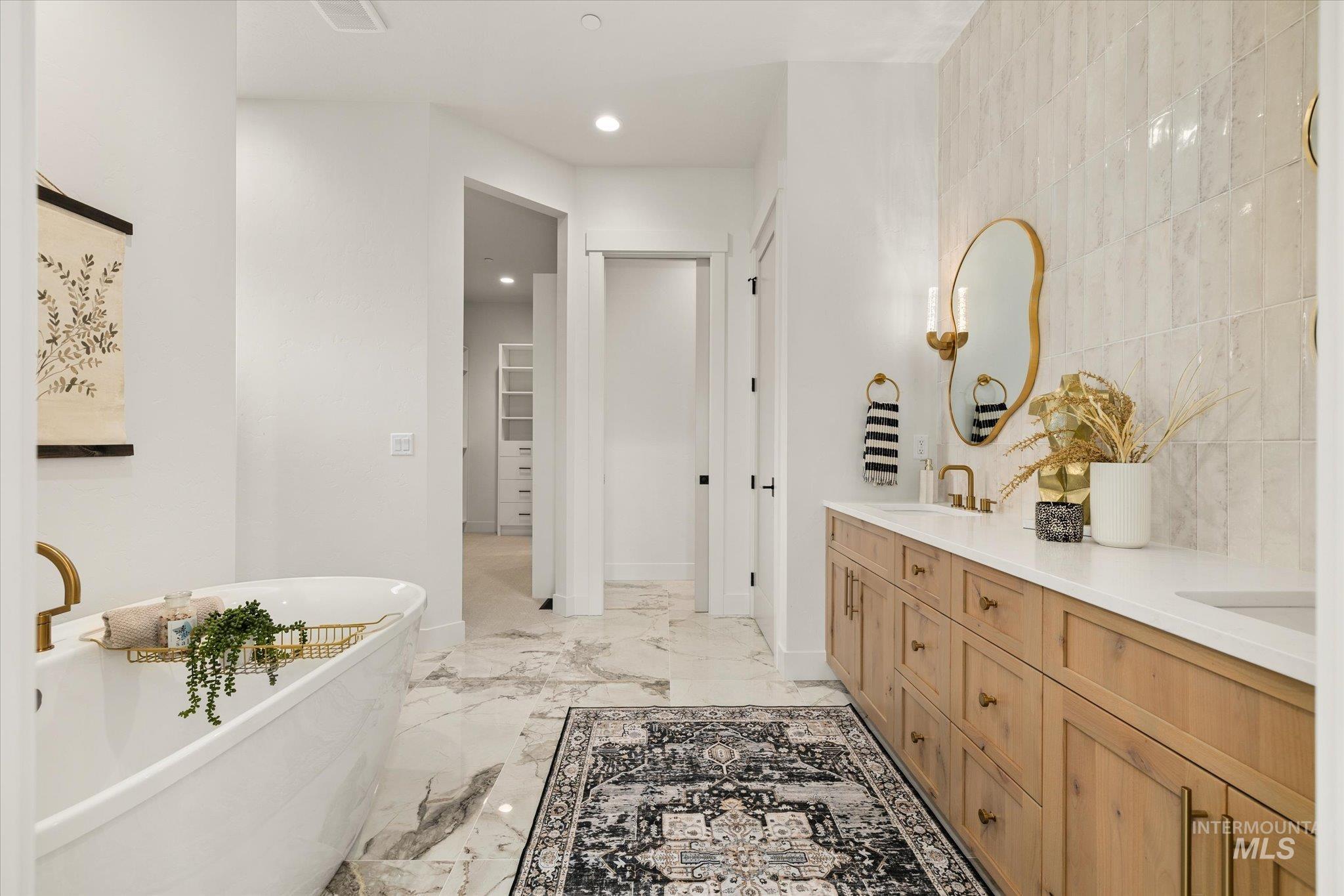 22909 Cirrus Vw Court Caldwell, ID 83607 - Photo 30 of 50 Bathroom with a freestanding bath, double vanity, recessed lighting, light marble finish flooring, and a walk in closet