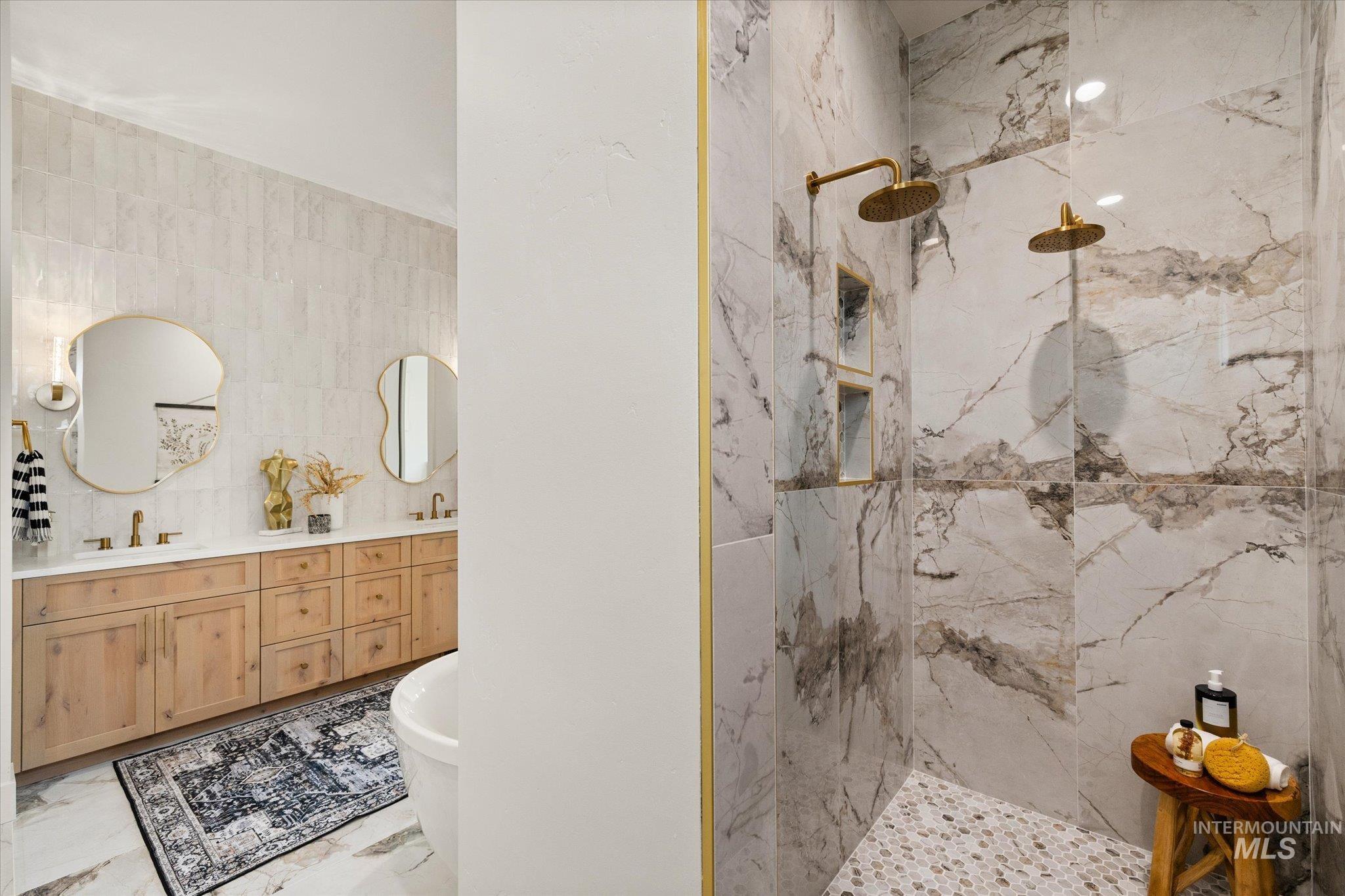 22909 Cirrus Vw Court Caldwell, ID 83607 - Photo 32 of 50 Full bathroom with a marble finish shower, a freestanding tub, double vanity, tile walls, and light marble finish floors