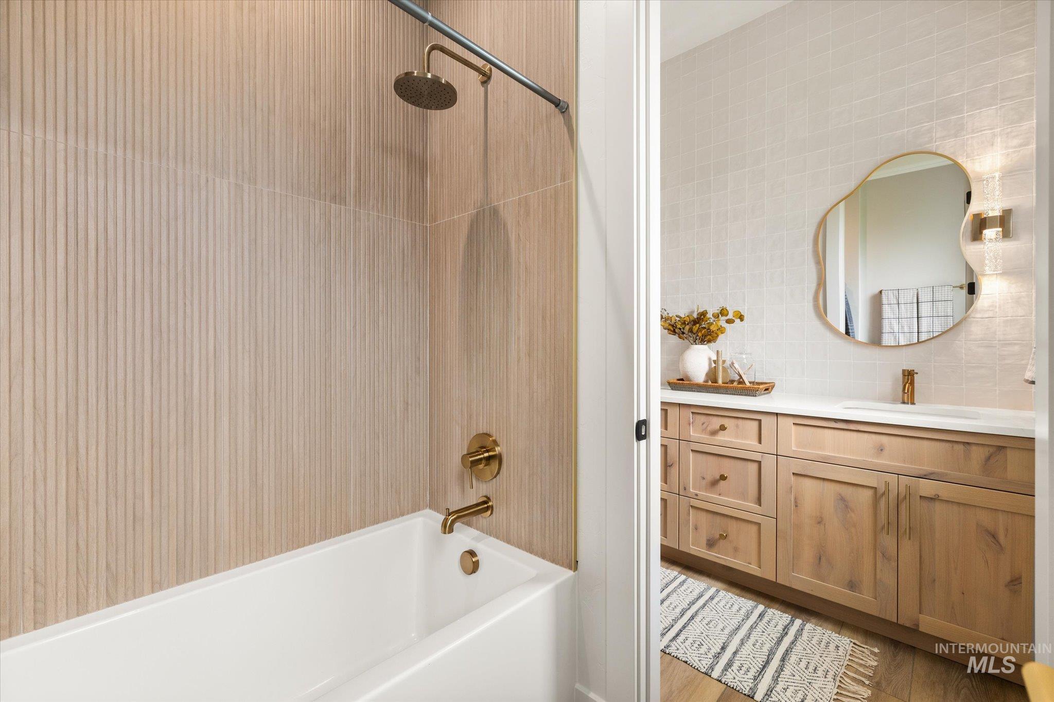 22909 Cirrus Vw Court Caldwell, ID 83607 - Photo 39 of 50 Full bathroom with shower / tub combination, vanity, backsplash, tile walls, and light wood finished floors