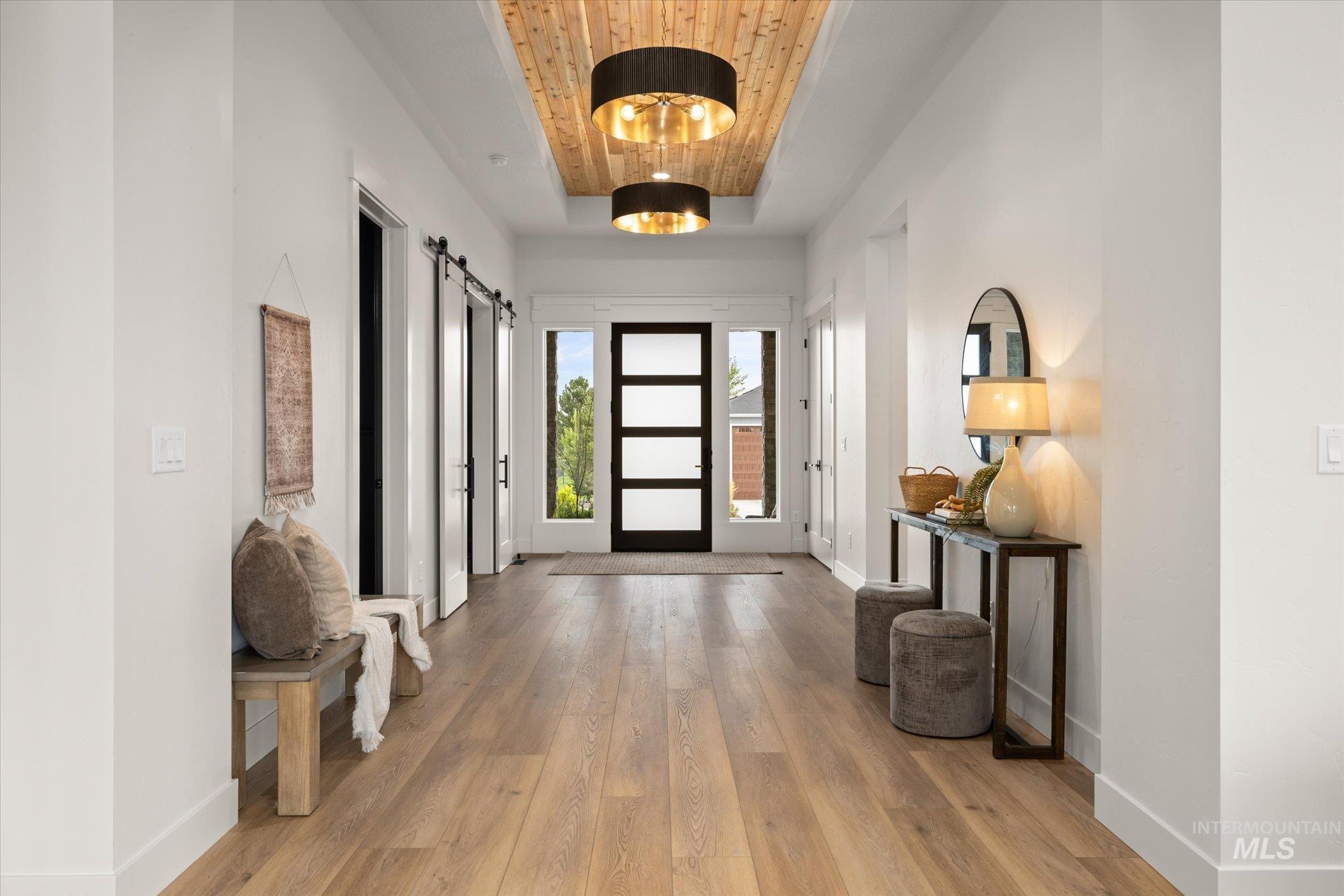 22909 Cirrus Vw Court Caldwell, ID 83607 - Photo 4 of 50 Entrance foyer with light wood-type flooring, a tray ceiling, a barn door, and wood ceiling