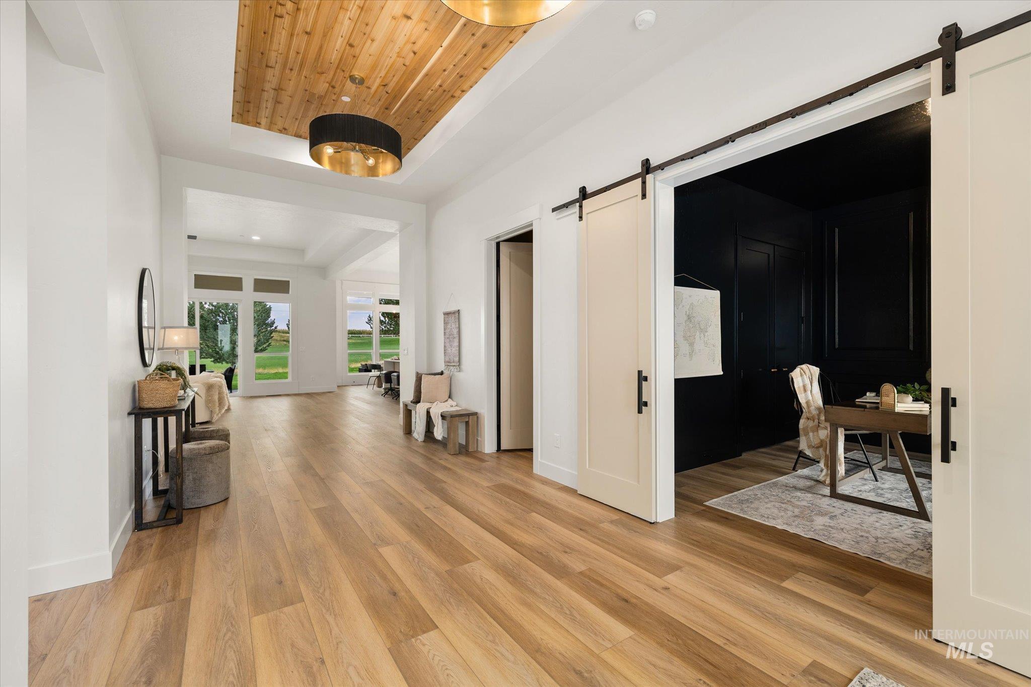 22909 Cirrus Vw Court Caldwell, ID 83607 - Photo 5 of 50 Hall with a barn door, a tray ceiling, light wood-type flooring, wood ceiling, and recessed lighting