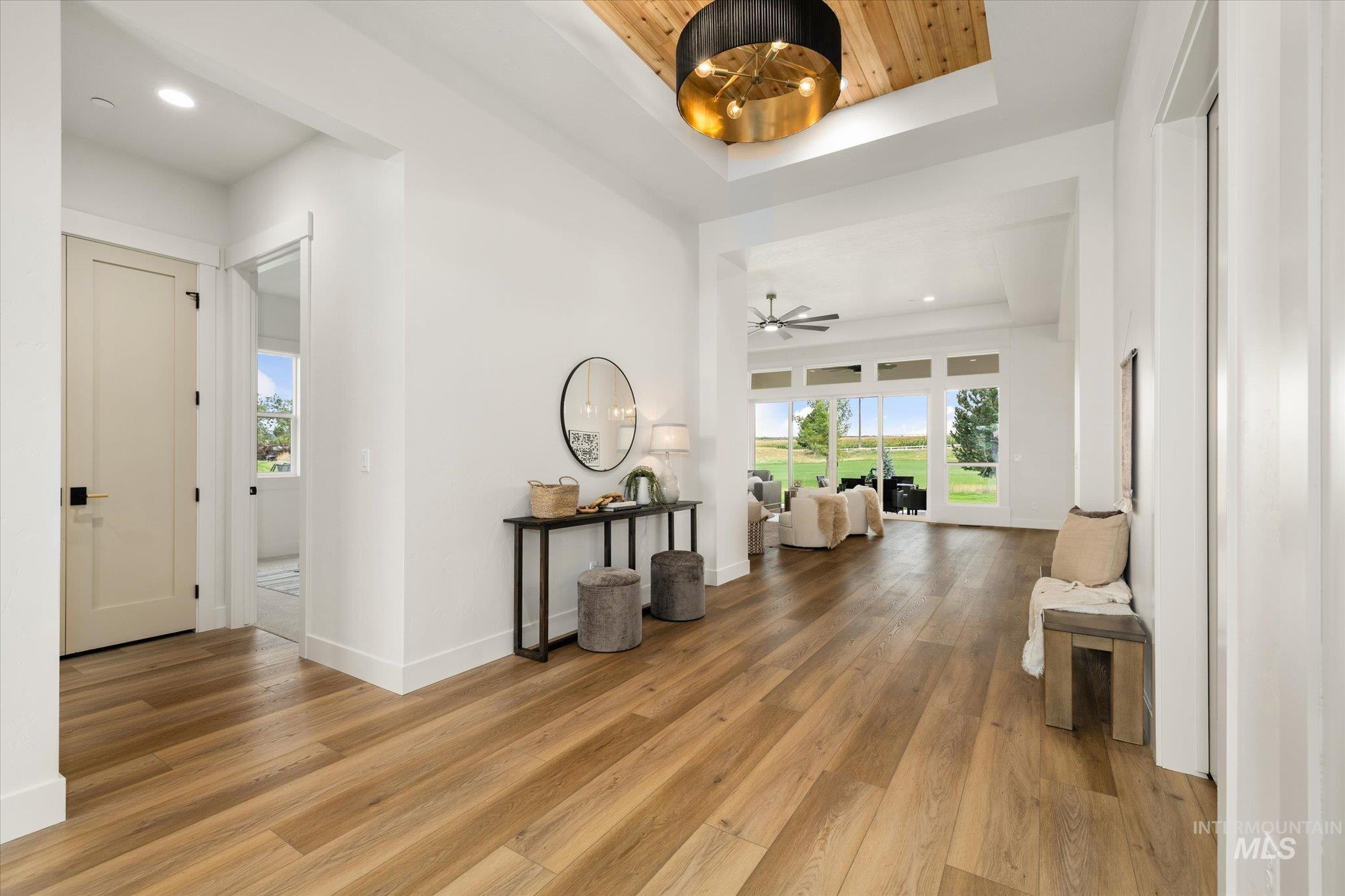 22909 Cirrus Vw Court Caldwell, ID 83607 - Photo 6 of 50 Corridor with a raised ceiling, light wood-style floors, healthy amount of natural light, and recessed lighting
