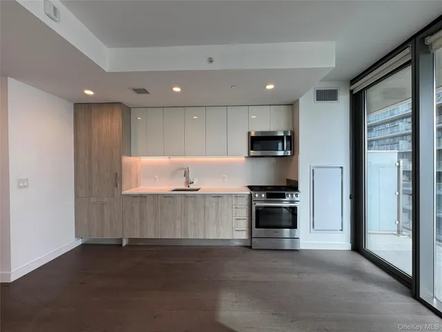a kitchen with stainless steel appliances granite countertop a stove and a refrigerator