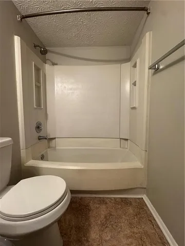 a bathroom with a toilet and a bathtub