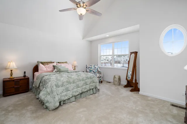 a spacious bedroom with a bed and a window