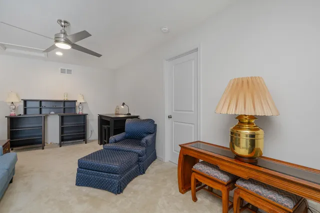 a living room with furniture and a lamp