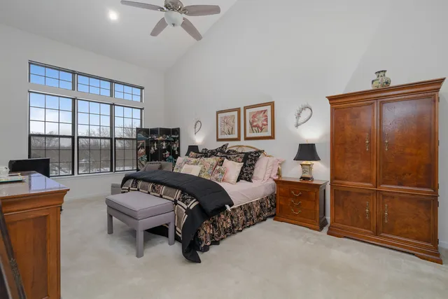 a spacious bedroom with a bed and a table in it