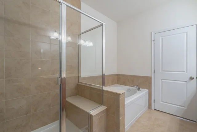 a bathroom with a bathtub and a shower